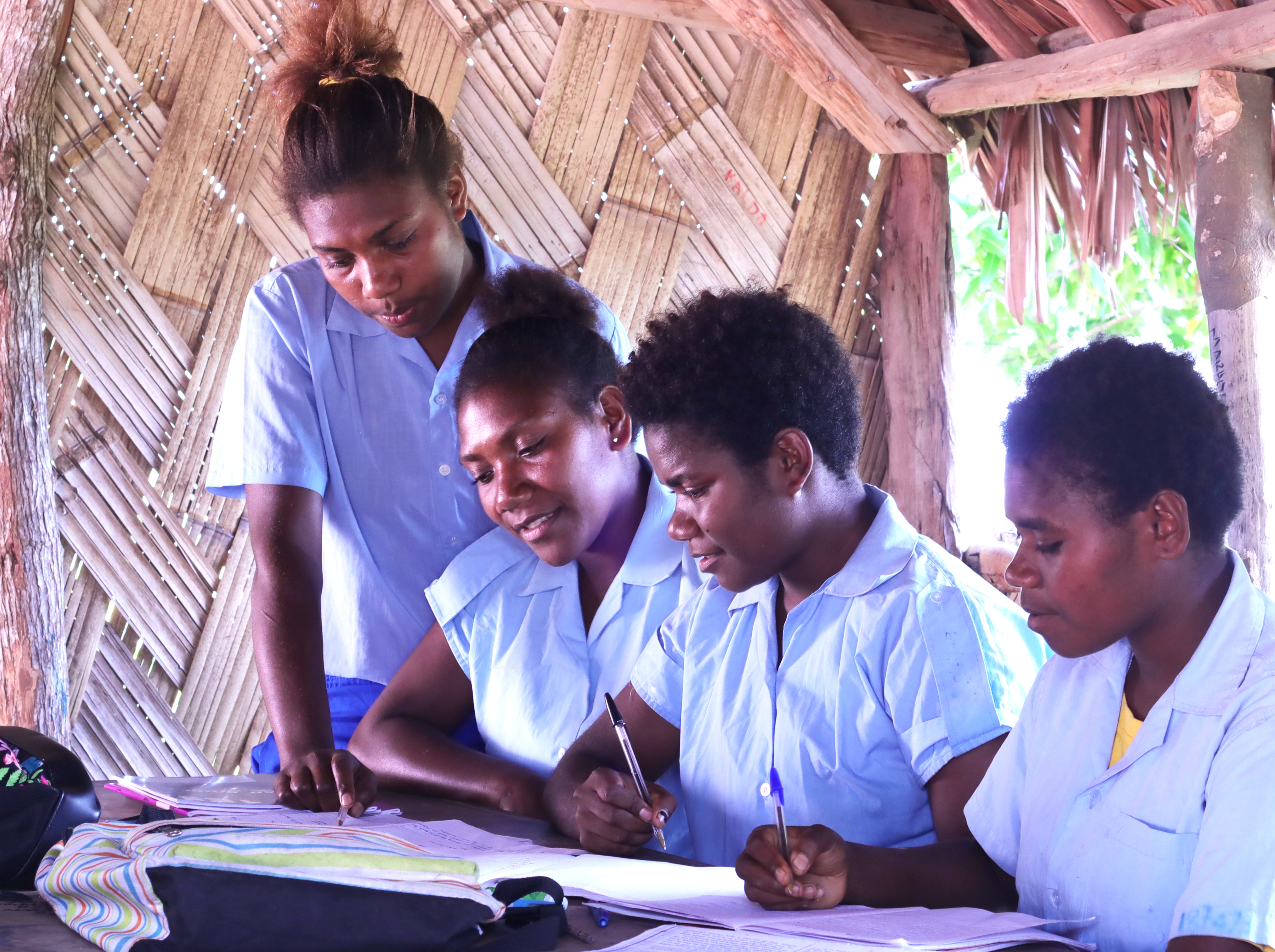 A group of students revising in their school bure at Tafea College, Tanna Island, Vanuatu
